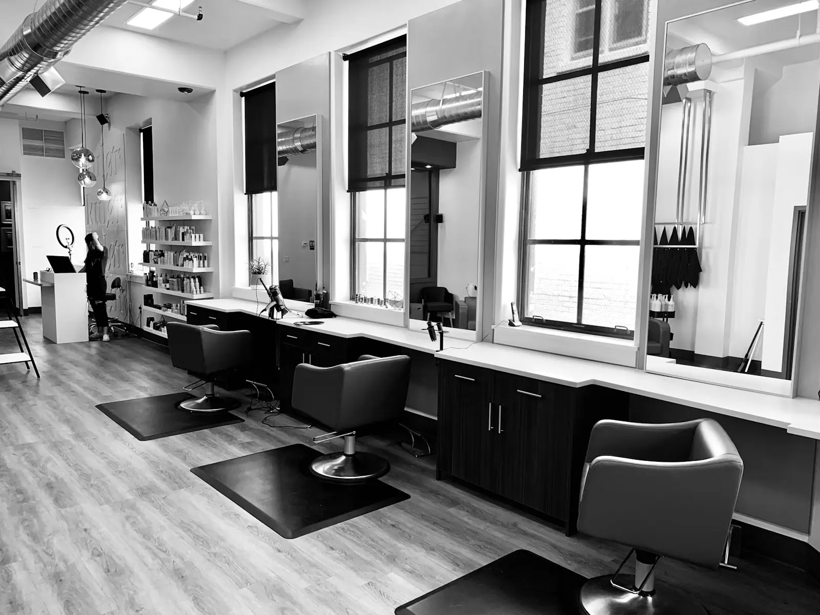 Stylist finishing a blowout in a warm salon space
